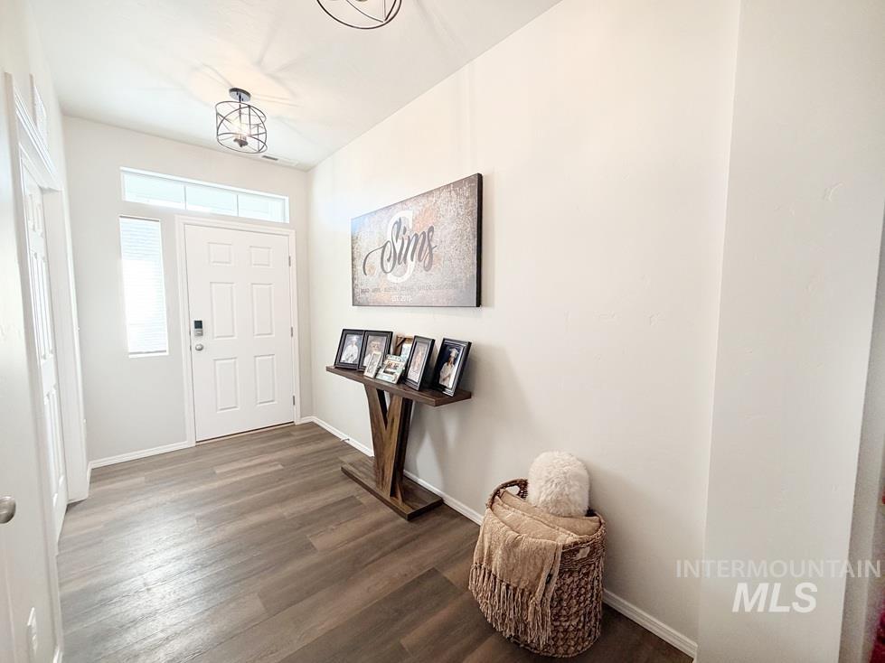 13694 Oliver Street Caldwell, ID 83607 - Photo 4 of 28 Entryway featuring baseboards and dark wood finished floors
