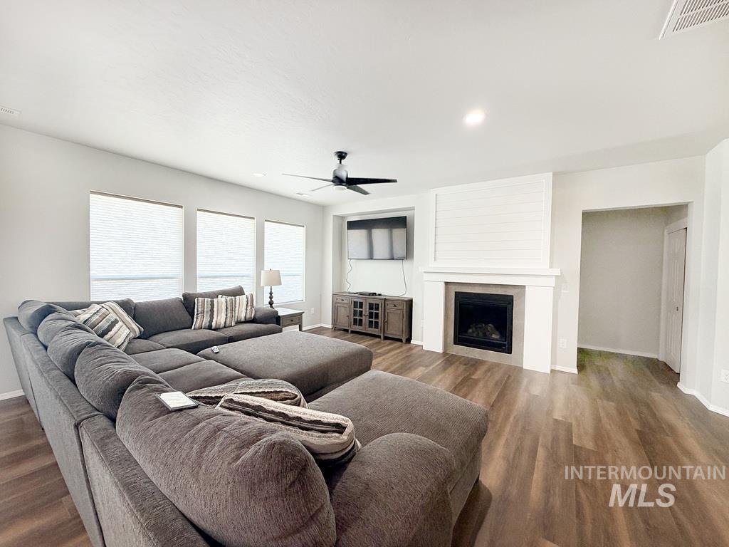 13694 Oliver Street Caldwell, ID 83607 - Photo 6 of 28 Living room with ceiling fan, recessed lighting, a fireplace, and dark wood-style flooring