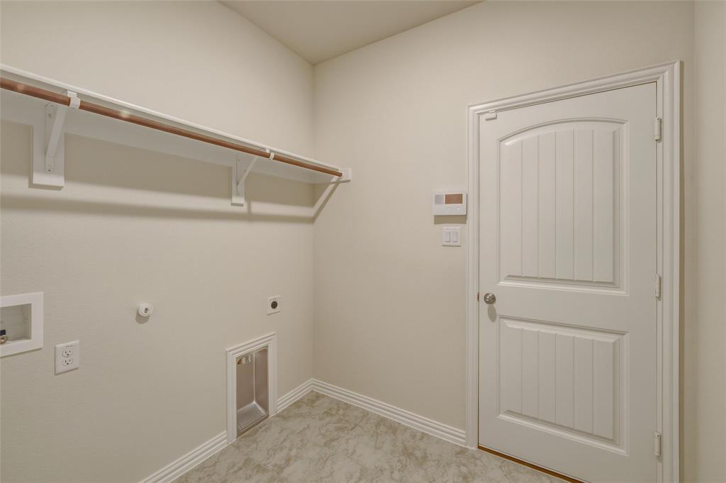 1217 Colca Drive Springtown, TX 76082 - Photo 19 of 25 Utility room featuring a hanging rod, integrated dryer vent, washer hookup, and wood-panel door