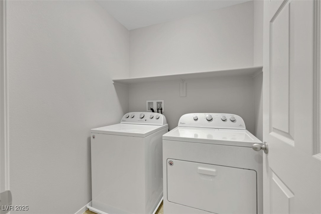 4549 Lime Straight Drive Las Vegas, NV 89115 - Photo 11 of 21 Washroom with washing machine and dryer and baseboards
