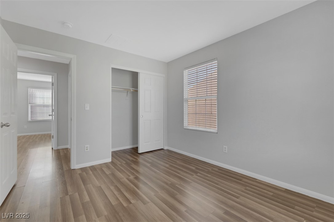 4549 Lime Straight Drive Las Vegas, NV 89115 - Photo 13 of 21 Unfurnished bedroom with light wood-type flooring and a closet
