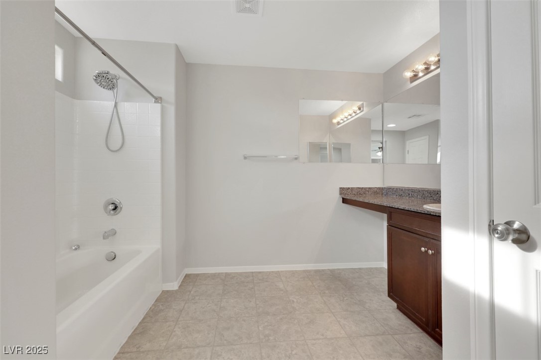 4549 Lime Straight Drive Las Vegas, NV 89115 - Photo 20 of 21 Full bath featuring tub / shower combination, vanity, and light tile patterned floors