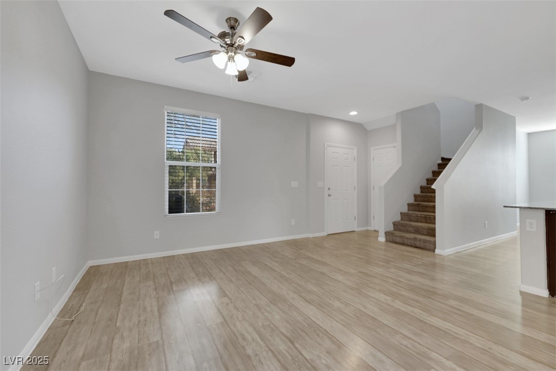 4549 Lime Straight Drive Las Vegas, NV 89115 - Photo 3 of 21 Unfurnished living room featuring stairway, light wood finished floors, ceiling fan, and recessed lighting
