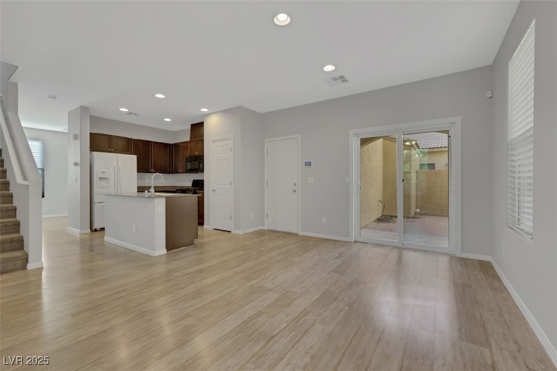 4549 Lime Straight Drive Las Vegas, NV 89115 - Photo 5 of 21 Unfurnished living room featuring stairs, light wood finished floors, and recessed lighting