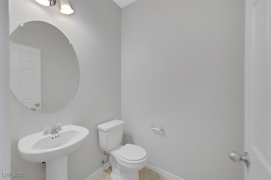 4549 Lime Straight Drive Las Vegas, NV 89115 - Photo 9 of 21 Bathroom with toilet and light tile patterned floors