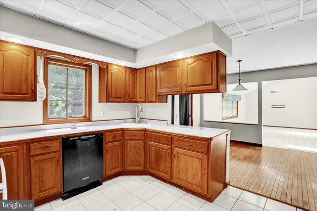 a kitchen with wooden cabinets and sink