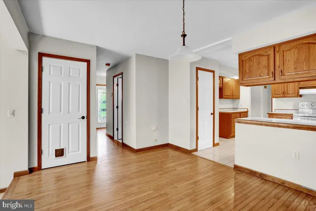 a view of a kitchen with wooden floor and a refrigerator