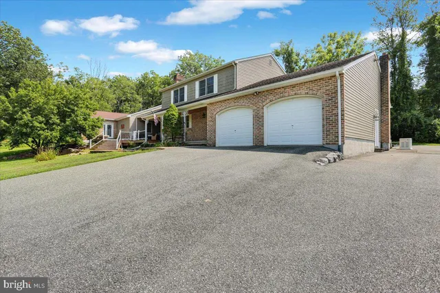 a view of a house with a yard and garage