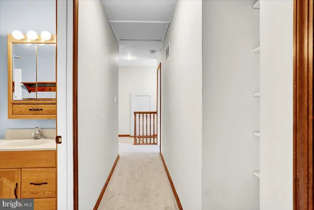 a view of a bathroom from a hallway