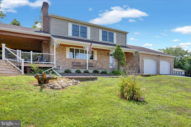 a front view of house with yard and outdoor seating