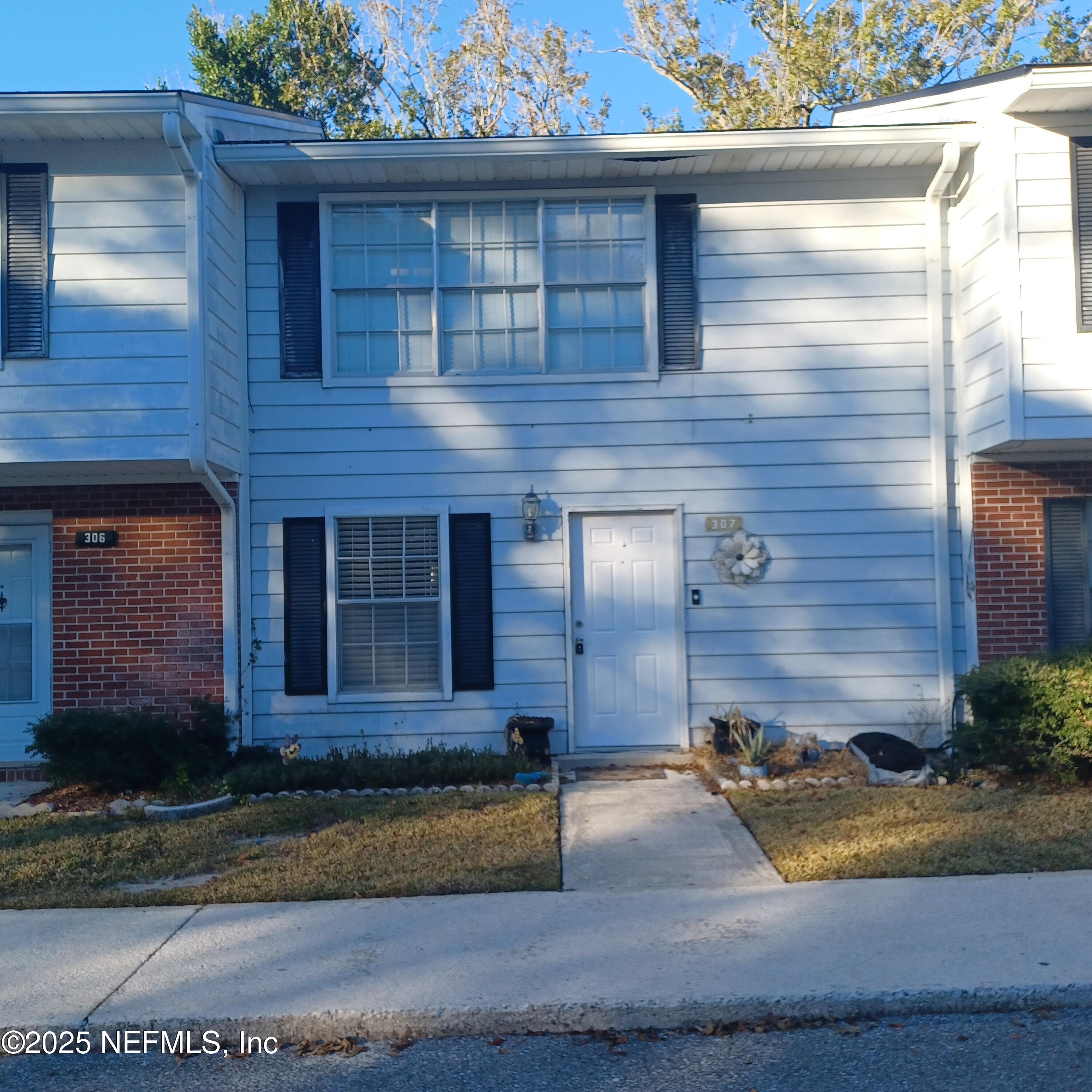 307 Kettering Terrace Orange Park, FL 32073 - Photo 1 of 16 a front view of a house with a yard and garage