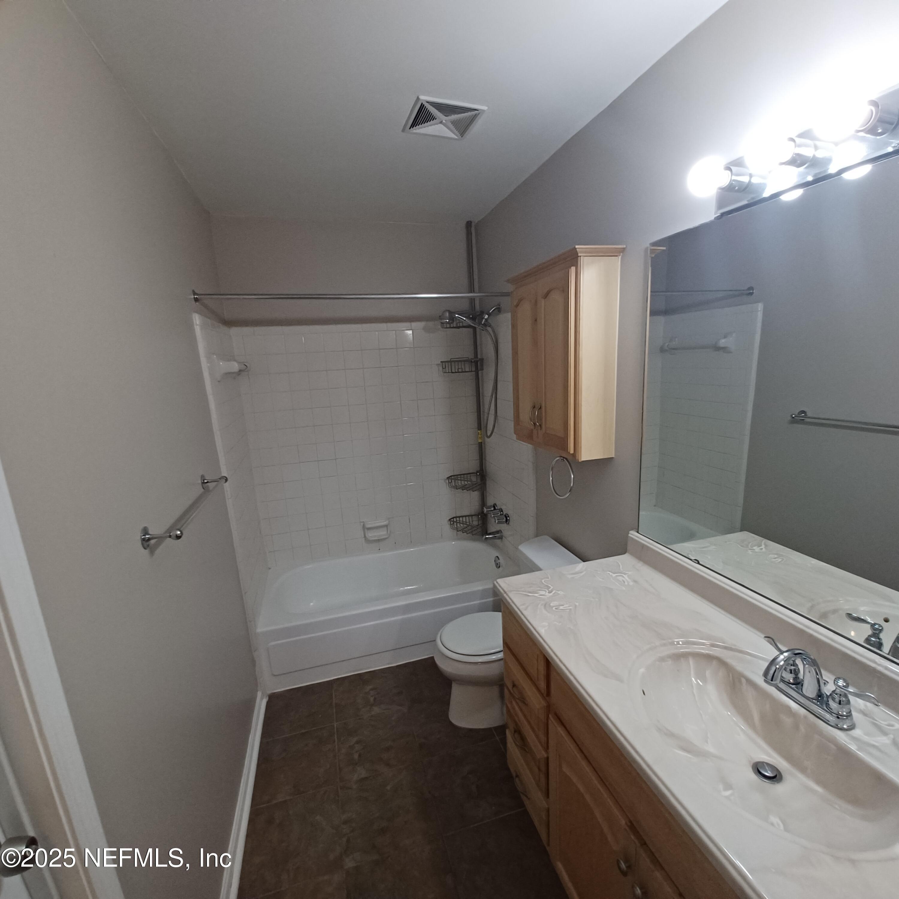 307 Kettering Terrace Orange Park, FL 32073 - Photo 15 of 16 a bathroom with a sink a toilet and shower