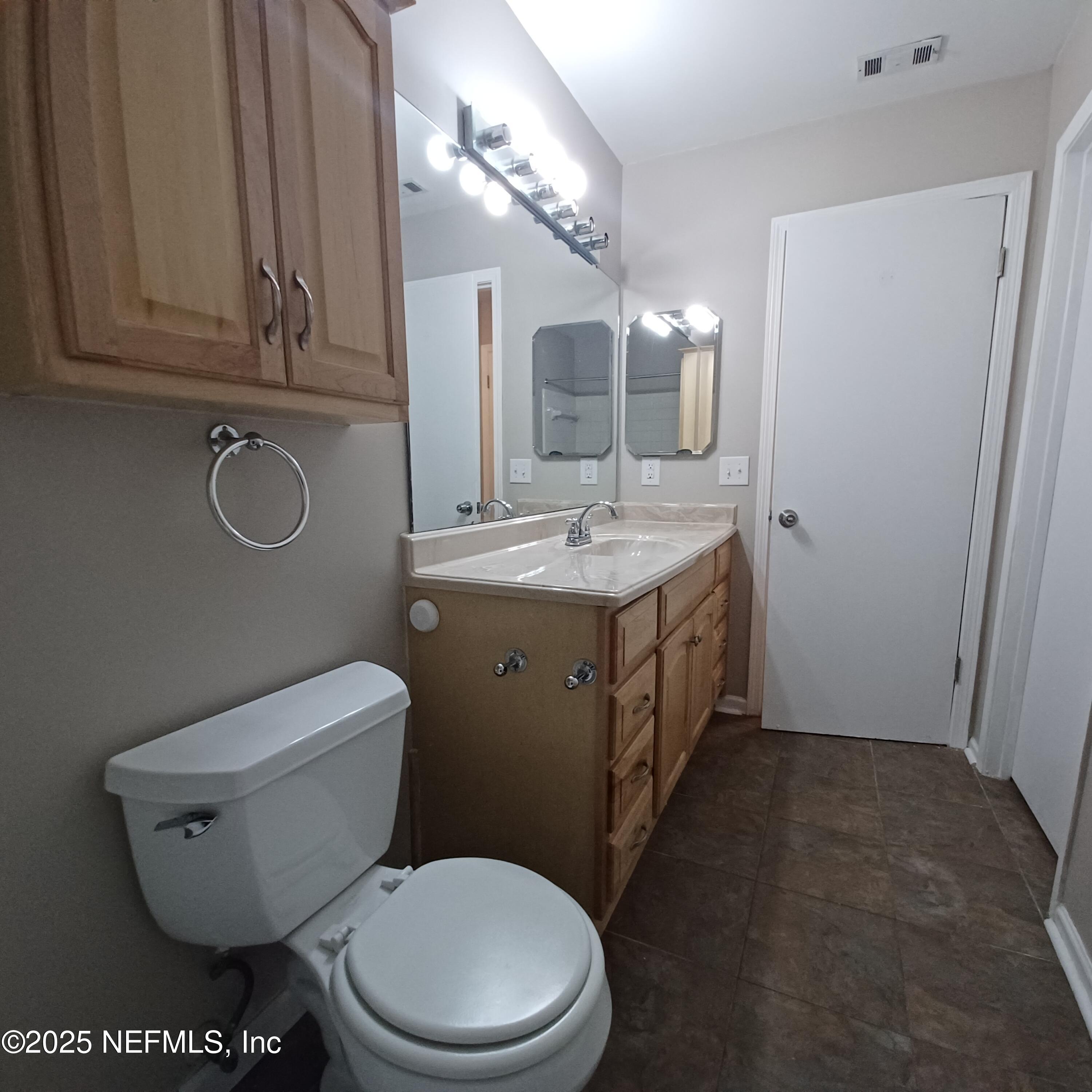 307 Kettering Terrace Orange Park, FL 32073 - Photo 16 of 16 a bathroom with a granite countertop toilet sink and mirror