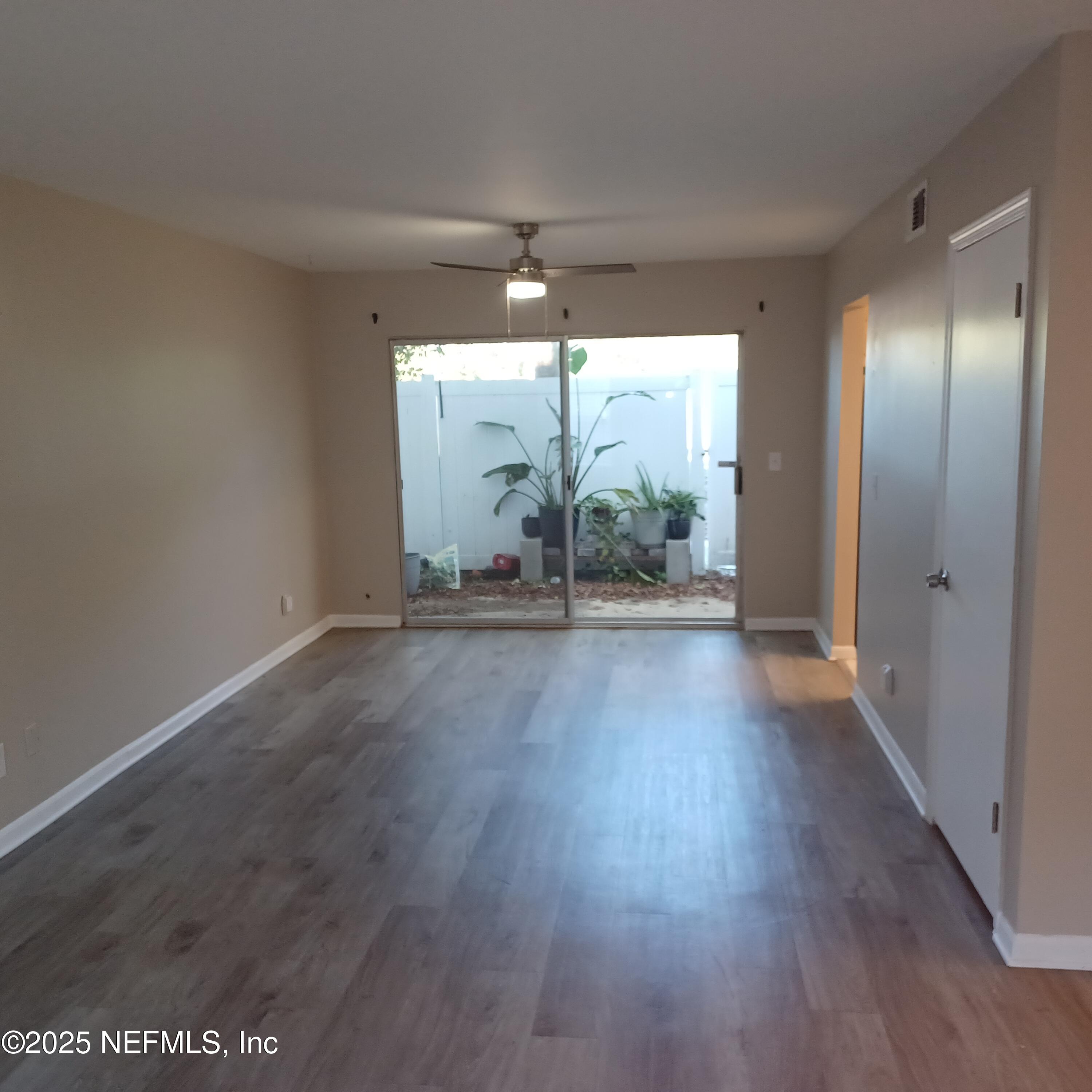 307 Kettering Terrace Orange Park, FL 32073 - Photo 2 of 16 an empty room with wooden floor and windows