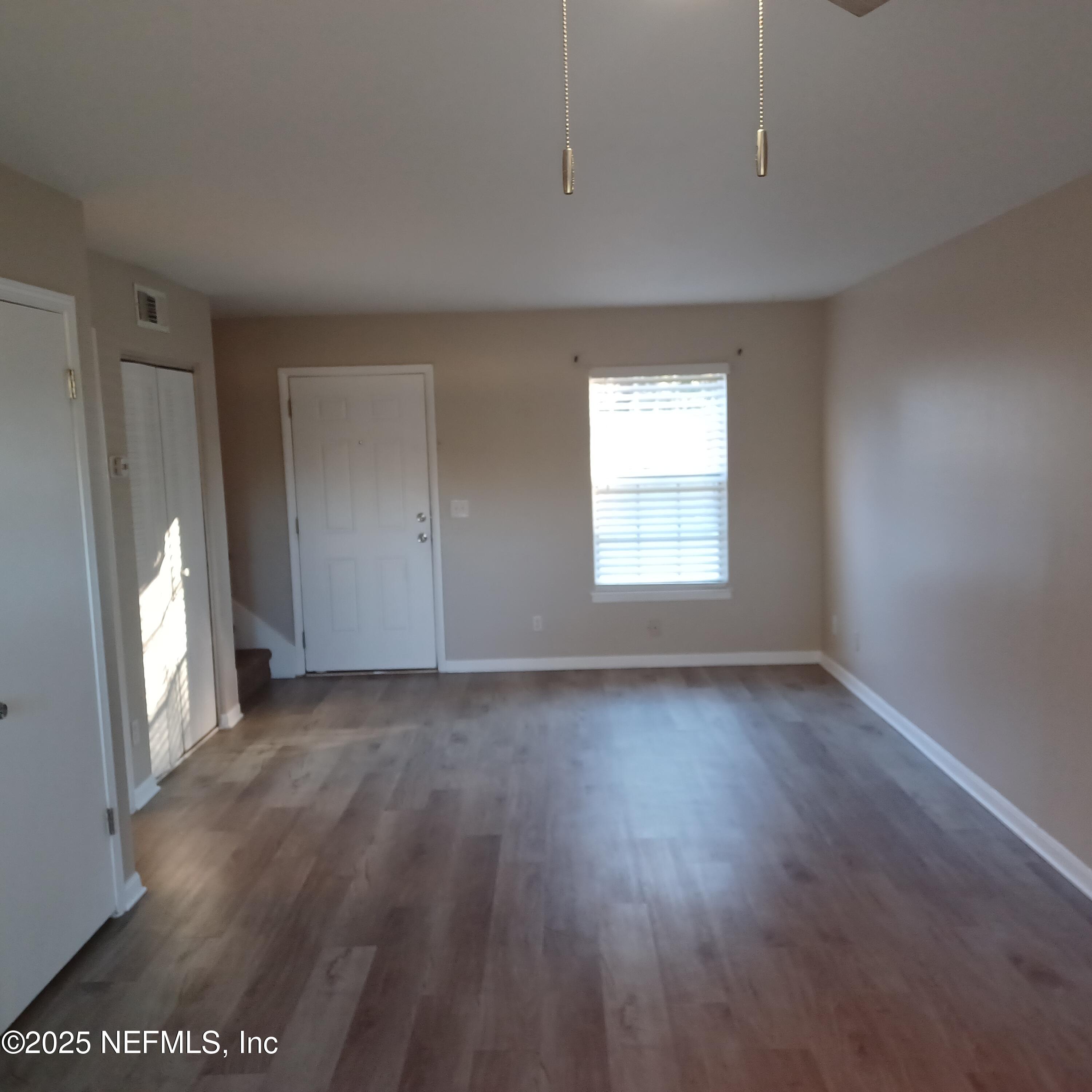 307 Kettering Terrace Orange Park, FL 32073 - Photo 3 of 16 an empty room with wooden floor and windows