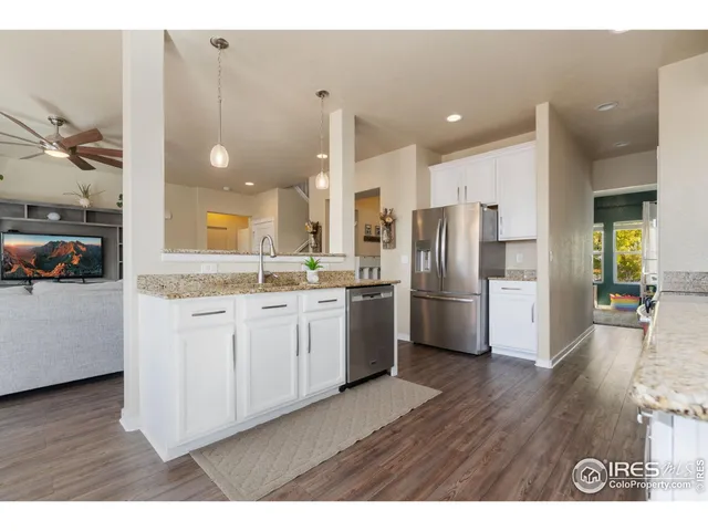 a kitchen with stainless steel appliances a refrigerator sink and cabinets