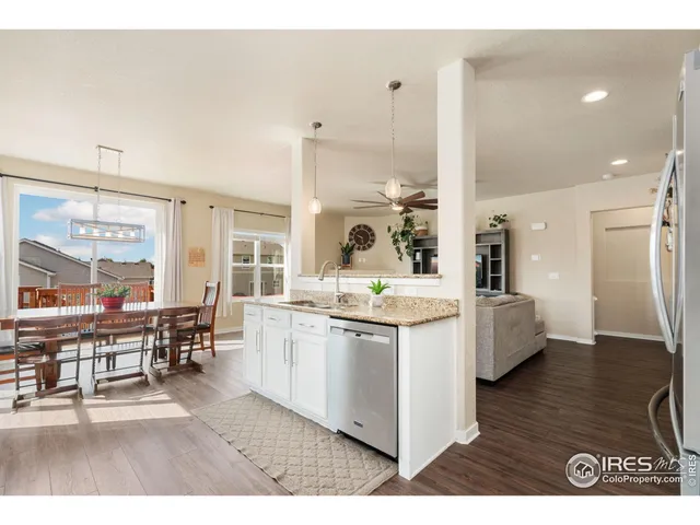 a large kitchen with stainless steel appliances kitchen island granite countertop a large kitchen island a stove a sink a dining table and chairs