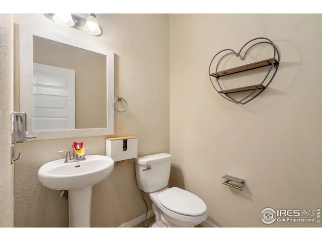 a bathroom with a sink a mirror and a toilet