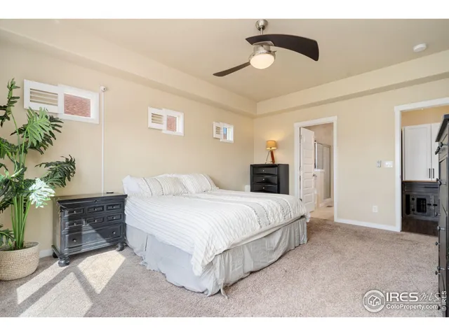 a spacious bedroom with a bed and a chandelier