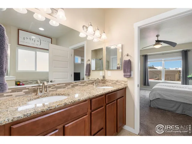 a bathroom with a granite countertop sink a large mirror and a