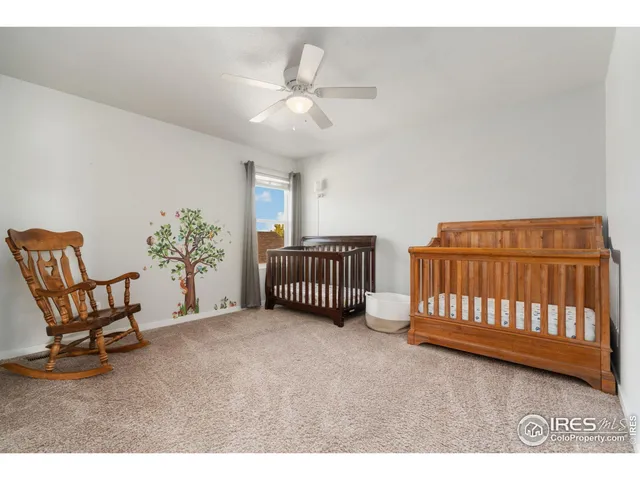 a spacious bedroom with a bed and a chair
