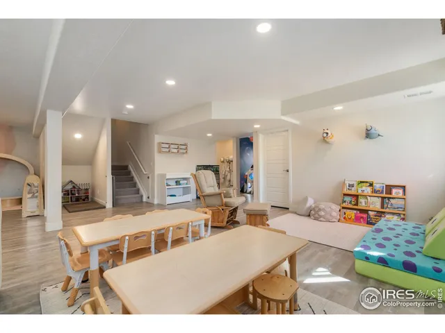 a living room with lots of furniture and kitchen view