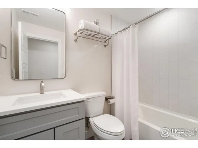 a bathroom with a toilet a sink and a mirror