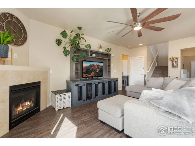 a living room with furniture a fireplace and a potted plant