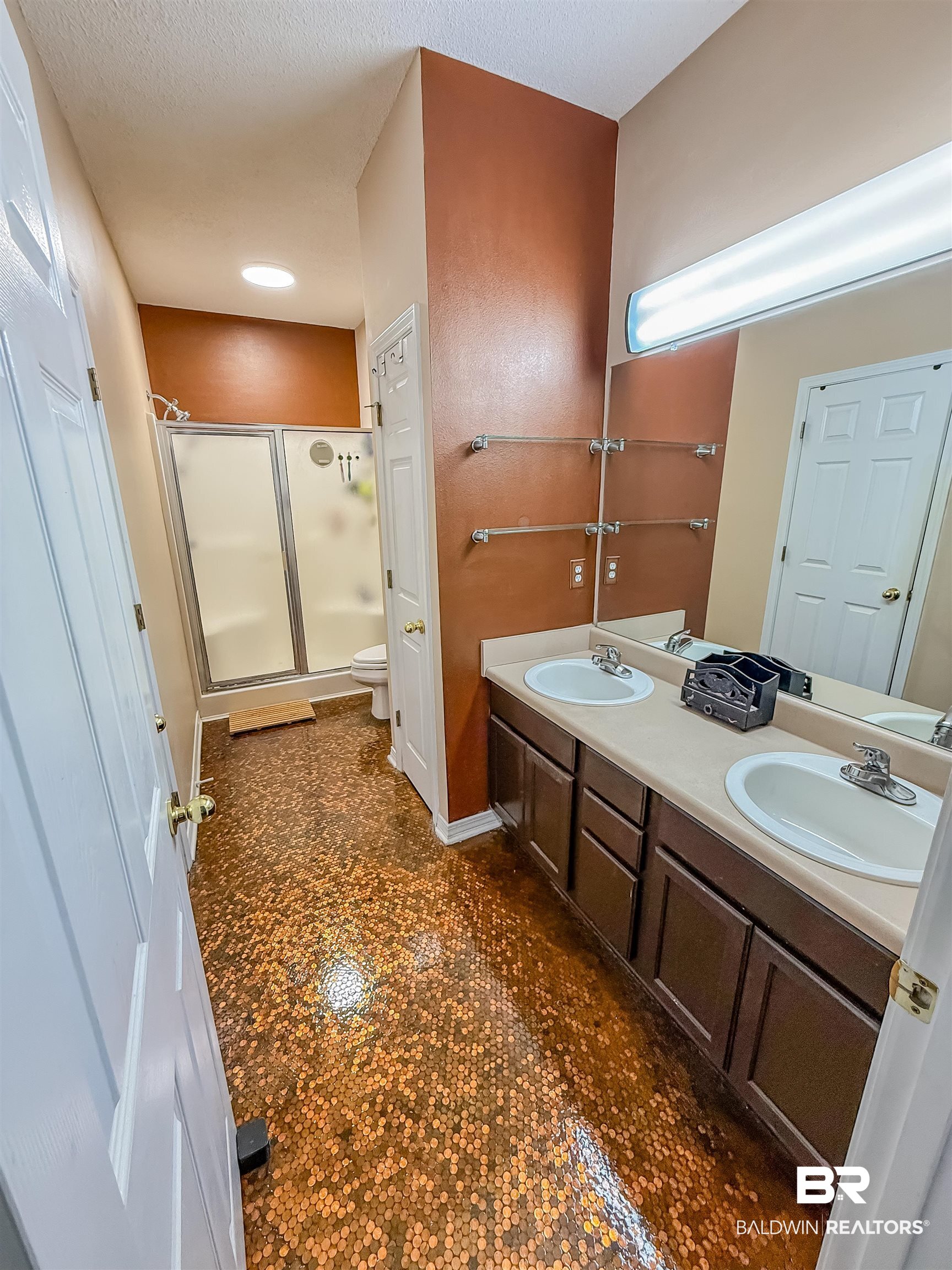 2651 South Juniper Street Foley, AL 36535 - Photo 8 of 20 Bathroom with double vanity, a shower stall, and a textured ceiling