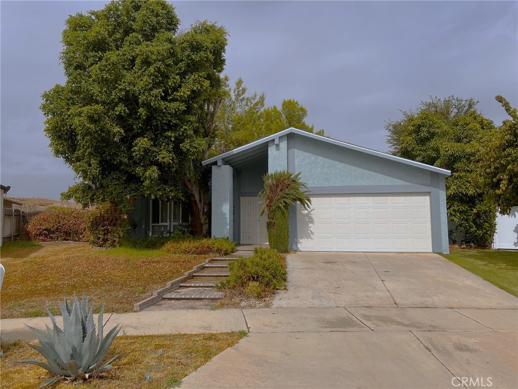 7083 Idyllwild Lane Riverside, CA 92503 - Photo 1 of 1 a front view of a house with a yard and garage