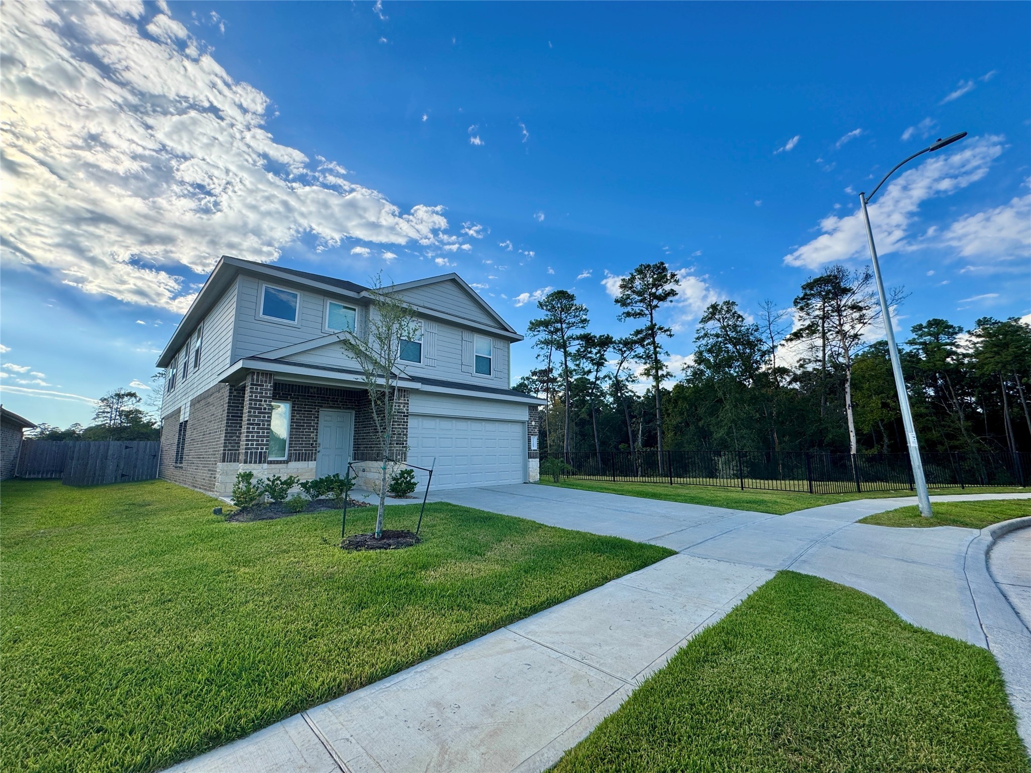 24463 Saffron Field Ln Spring Spring, TX 77373 - Photo 3 of 14 a front view of a house with garden