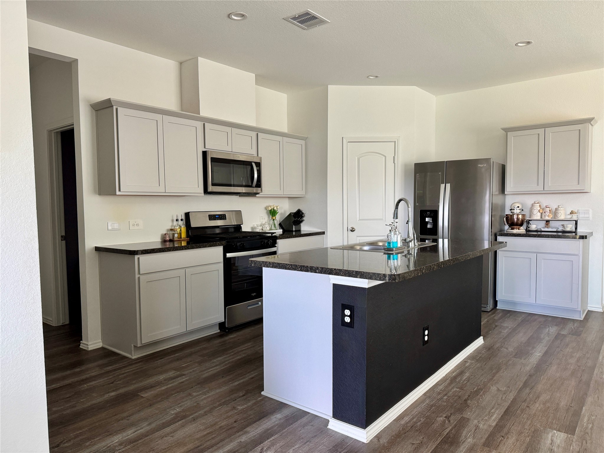 24463 Saffron Field Ln Spring Spring, TX 77373 - Photo 5 of 14 a kitchen with kitchen island granite countertop a refrigerator stove top oven and sink