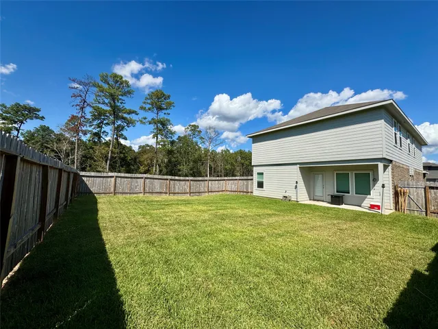 a view of a house with a backyard