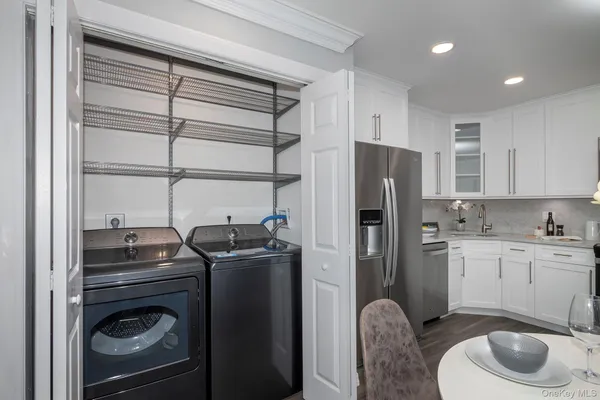 a kitchen with stainless steel appliances granite countertop a refrigerator sink and stove