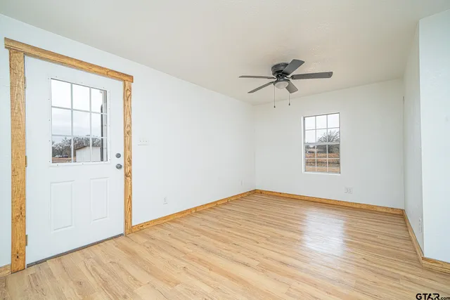 wooden floor in an empty room with a window