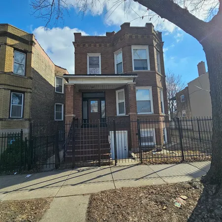 a view of a brick house with many windows