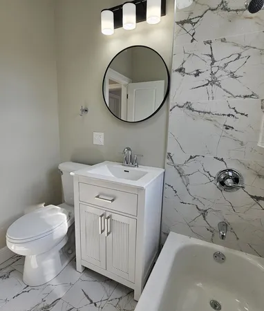 a kitchen with granite countertop a refrigerator stove and sink