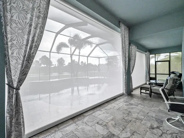 a view of a patio with a table chairs and a potted plant