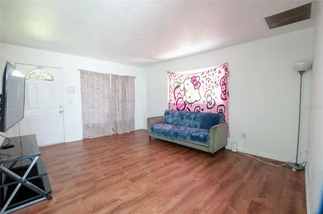 a view of a room with wooden floor and cabinet