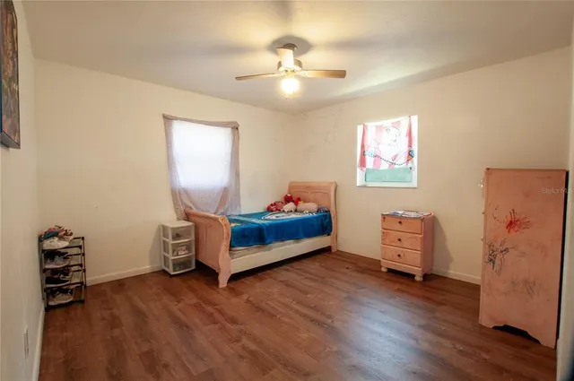 a bedroom with furniture and a window