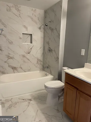 a bathroom with a sink a toilet and a bathtub