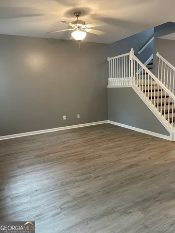 a view of an empty room with wooden floor