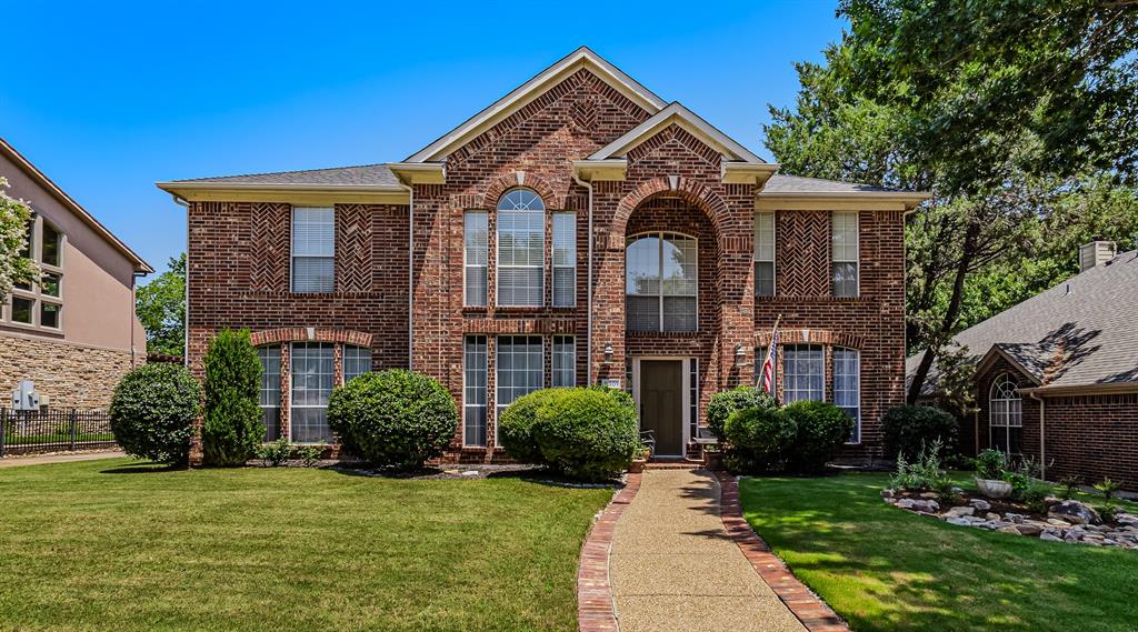 9301 Nottingham Court Rowlett, TX 75088 - Photo 1 of 39 Brick-clad exterior featuring arched window details and a prominent front entry