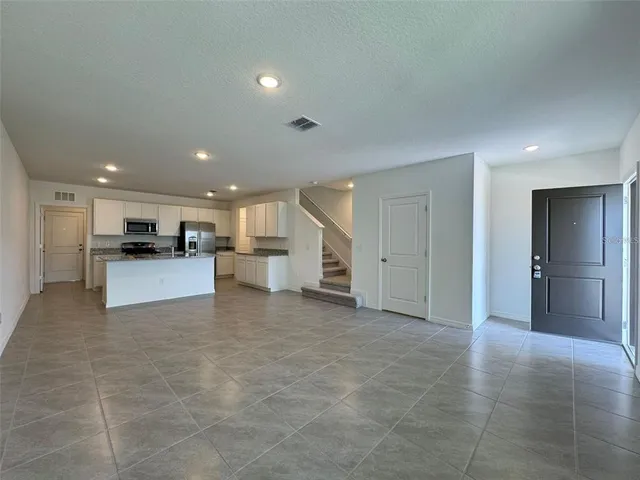 a view of kitchen with kitchen island and stainless steel appliances