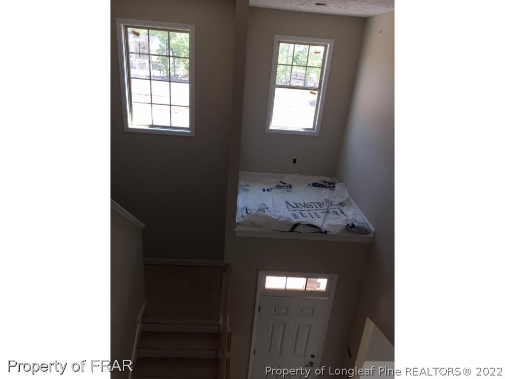 4778 McKinnon Farm Road Fayetteville, NC 28304 - Photo 13 of 18 a bed sitting in a bedroom next to a window