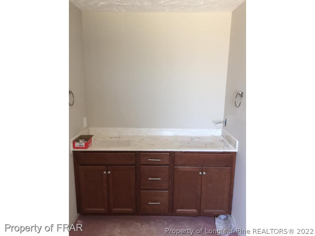 4778 McKinnon Farm Road Fayetteville, NC 28304 - Photo 16 of 18 a bathroom with a sink and a mirror