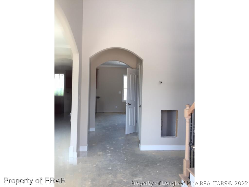 4778 McKinnon Farm Road Fayetteville, NC 28304 - Photo 3 of 18 a view of a hallway with wooden floor