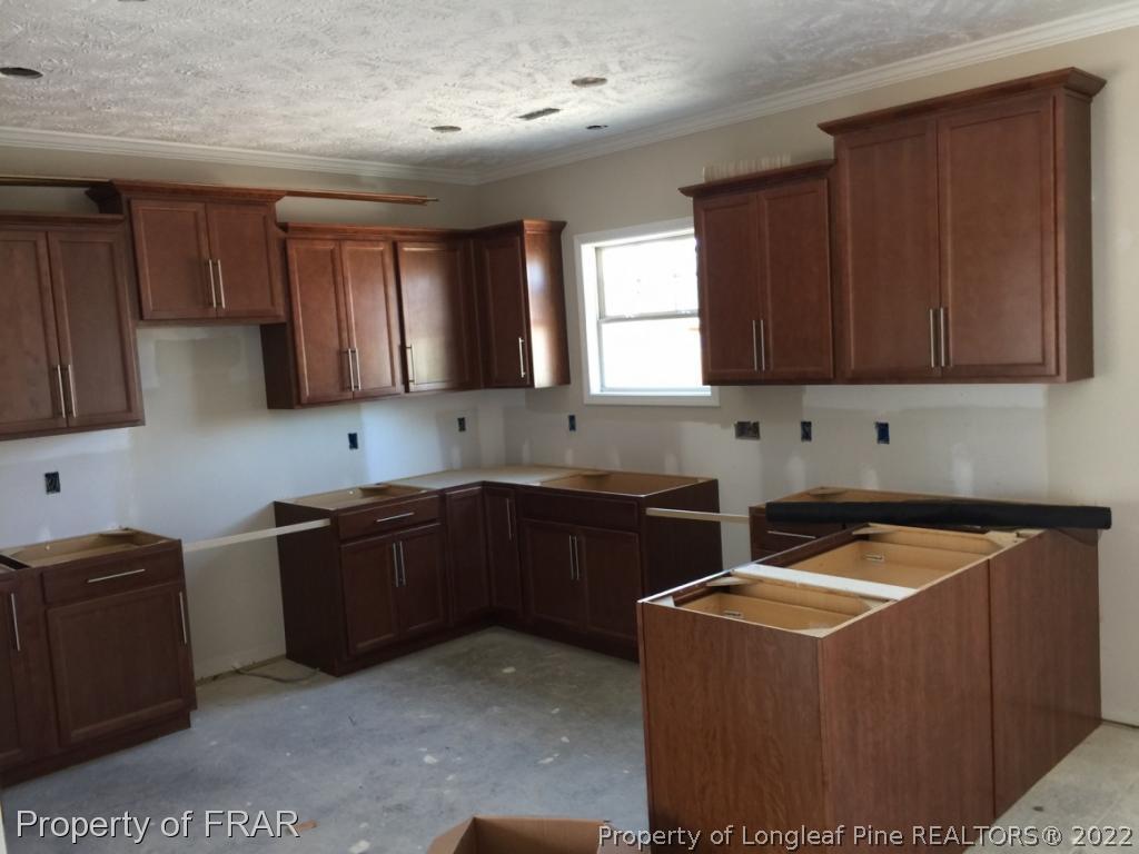 4778 McKinnon Farm Road Fayetteville, NC 28304 - Photo 7 of 18 a kitchen with stainless steel appliances granite countertop a stove a sink dishwasher and a refrigerator