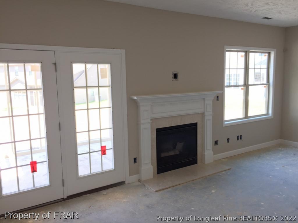 4778 McKinnon Farm Road Fayetteville, NC 28304 - Photo 10 of 18 an empty room with windows and fireplace