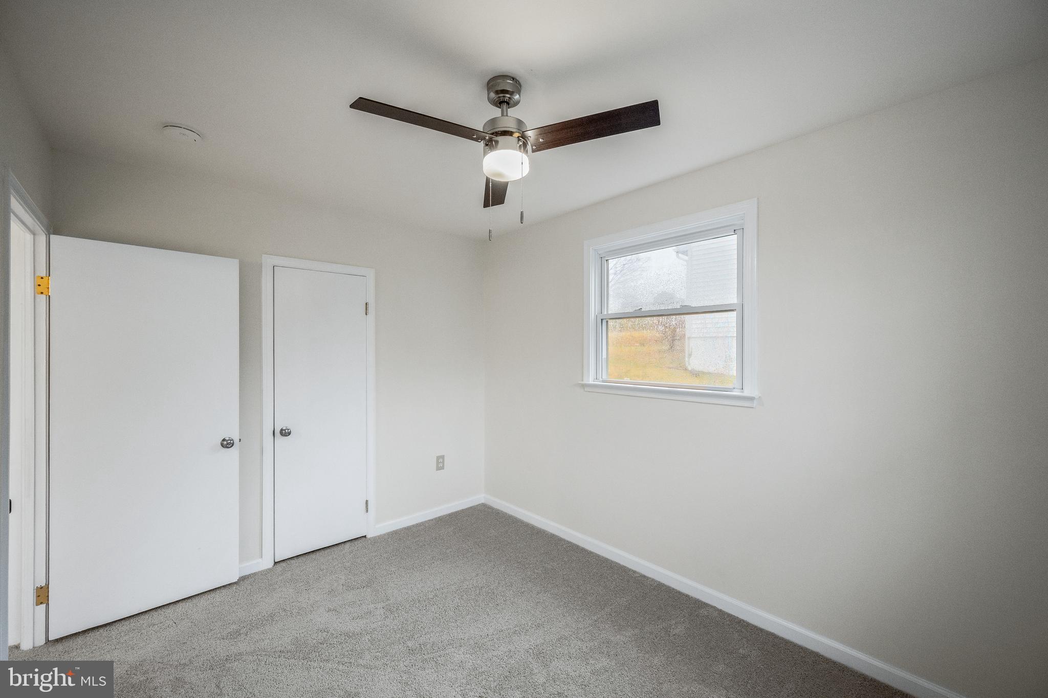 6 Mountain Road Linthicum Heights, MD 21090 - Photo 17 of 41 an empty room with a window and a ceiling fan
